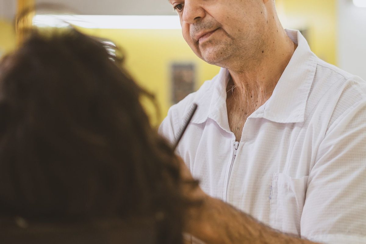 Barber working on a client's hair in the shop