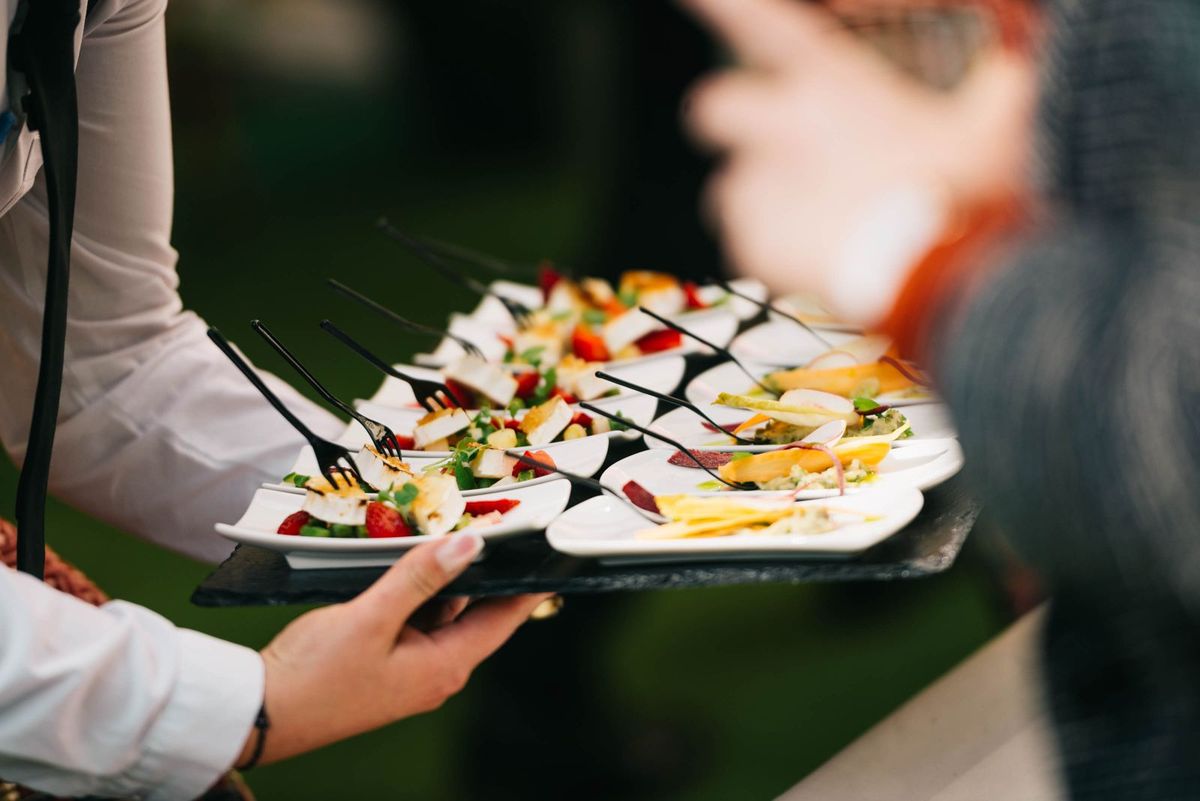 Waiter serving a tray of canapes at a catered event