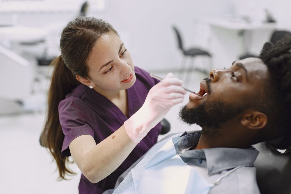 Dental hygienist treating a relaxed patient in a bright modern clinic