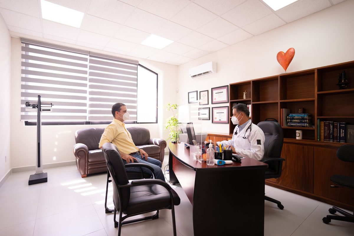 Bright, welcoming dental clinic consultation room with a patient and dentist