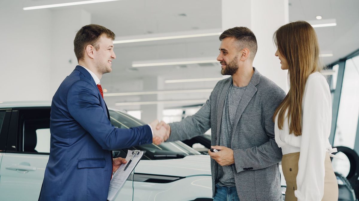 A happy customer shaking hands with a business owner