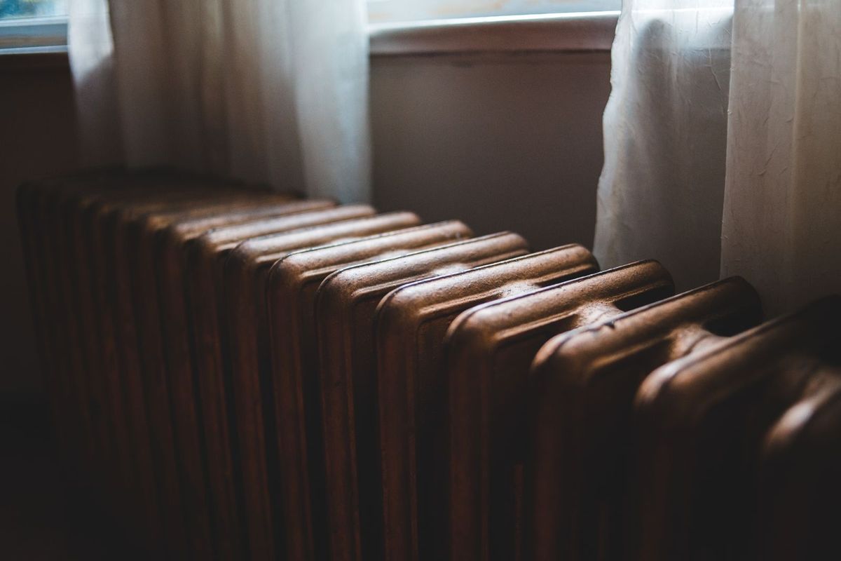A warm radiator by a window in a home