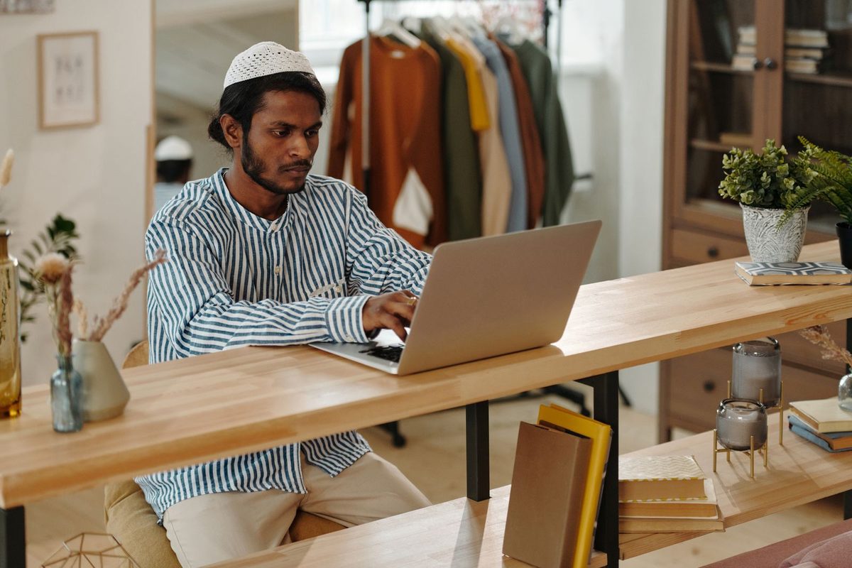 Small business owner working on a laptop in their shop