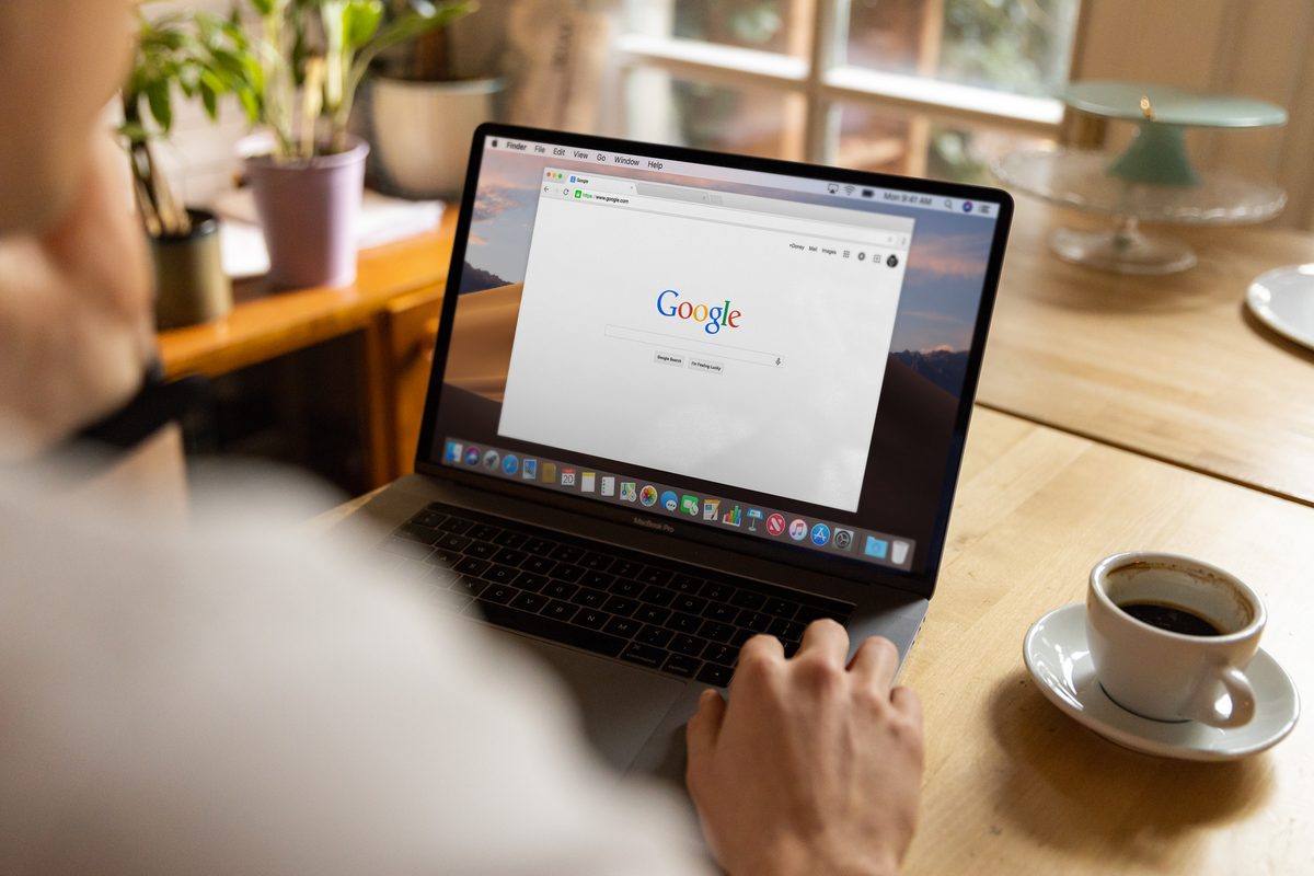 Person at a laptop with a browser open, choosing a domain name