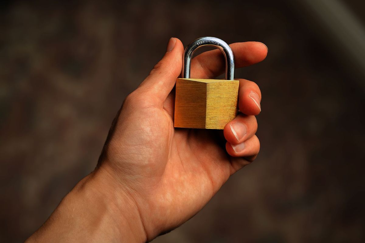 Hand holding a padlock