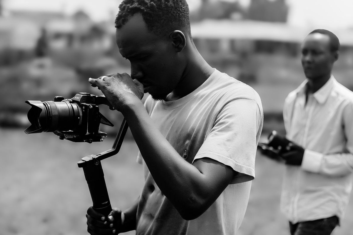 Person taking photographs with a camera outdoors