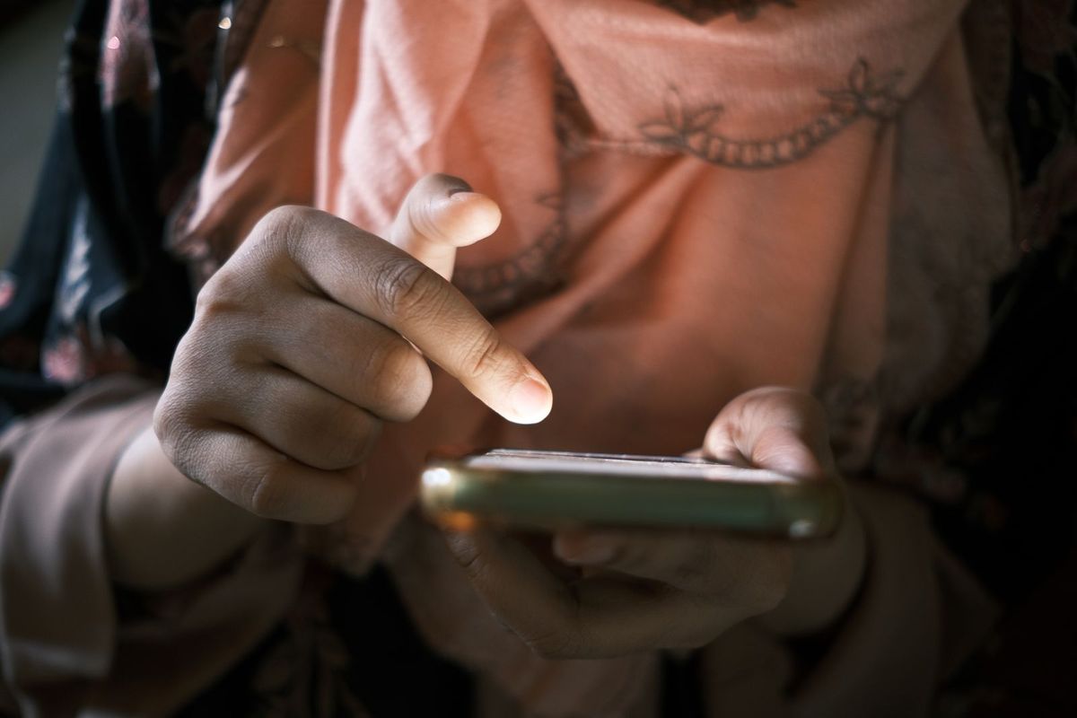 Person typing a search into a phone