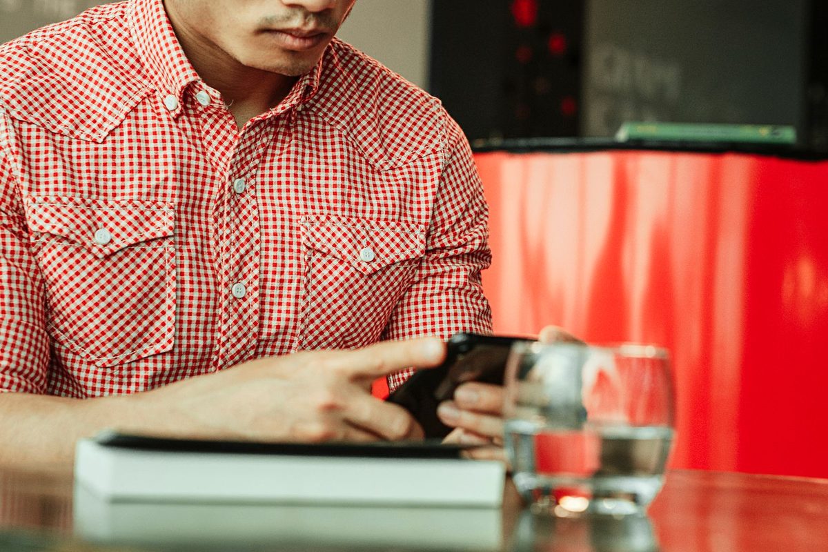 Person looking up a local business online at a cafe
