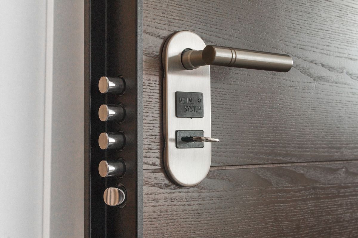 A close-up of a door lock with a key