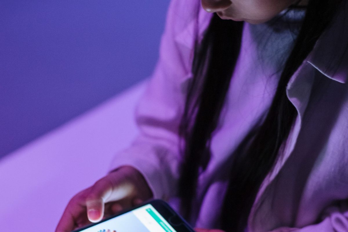 Person using a website on a smartphone in the evening