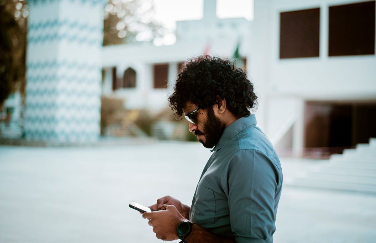 Person checking their phone to find a nearby business