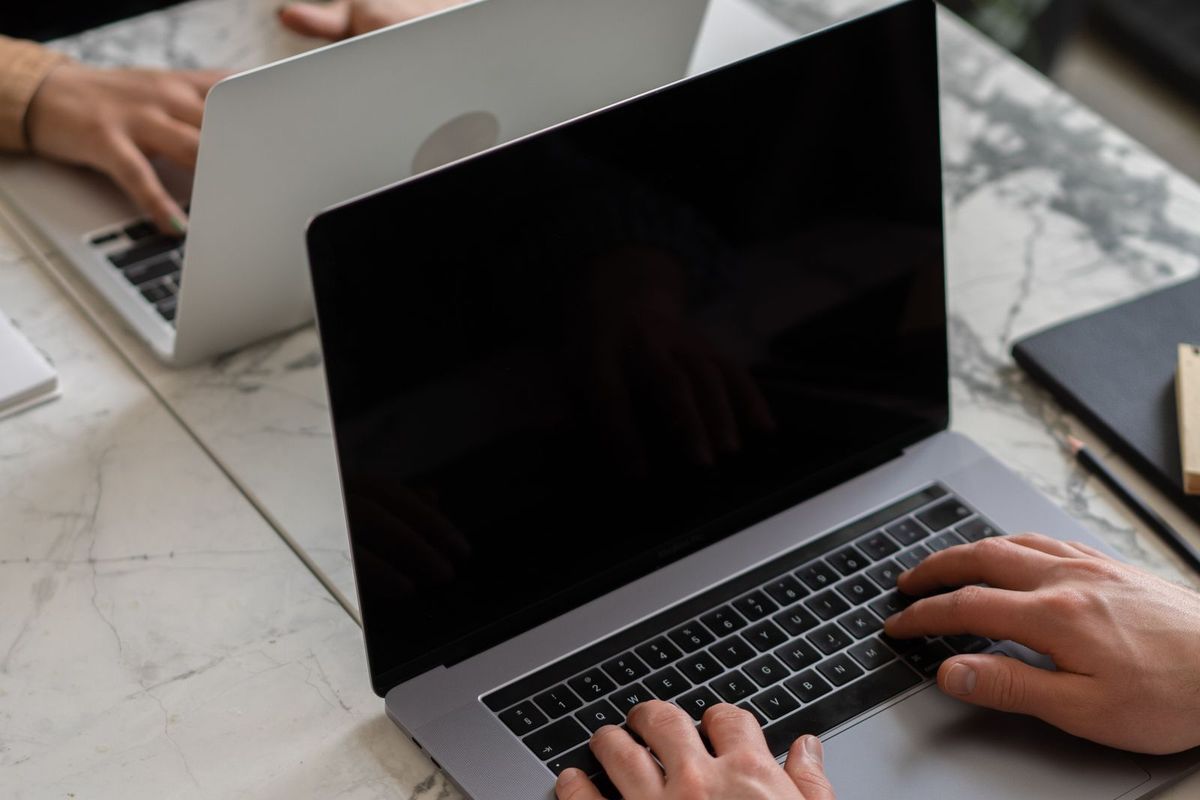 Person planning a website structure on a laptop