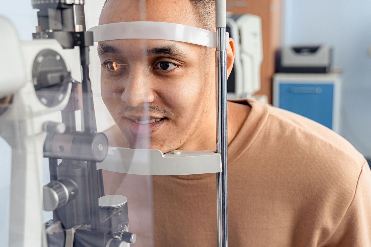 A patient having an eye examination on optical equipment