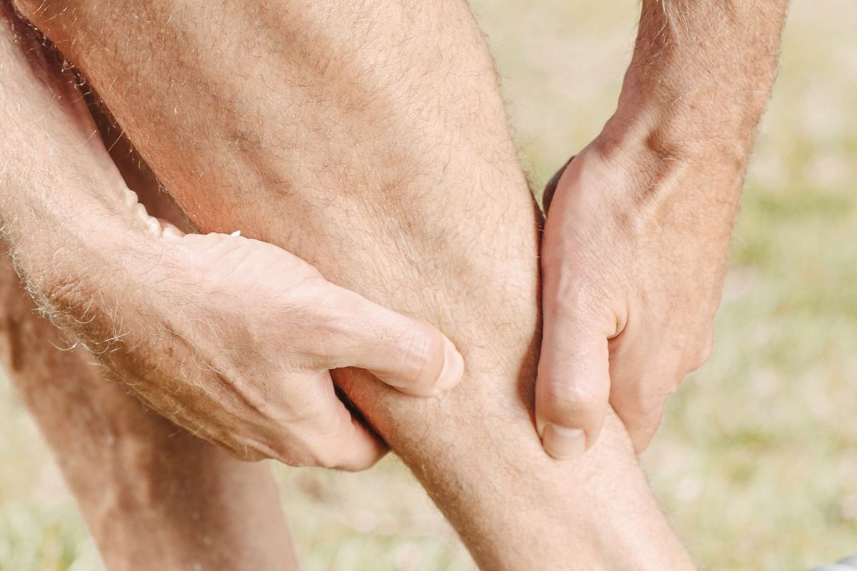 Physiotherapist treating a runner's lower leg injury