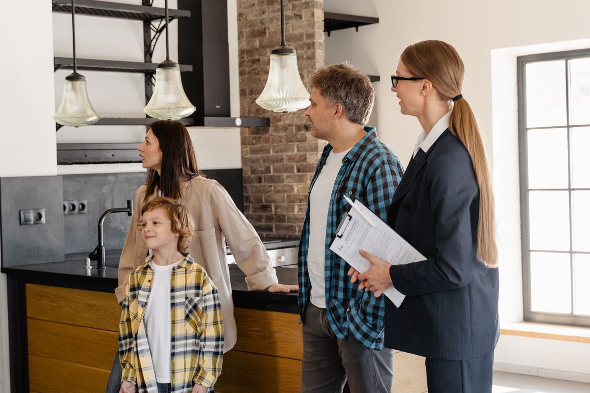 Family viewing a home with an estate agent
