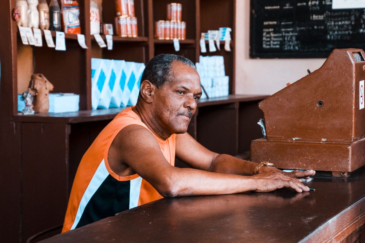 Shopkeeper at the counter of a small independent store