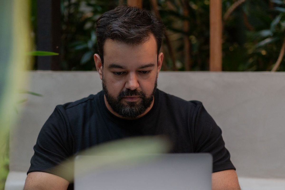 Person thinking through a customer question at a laptop