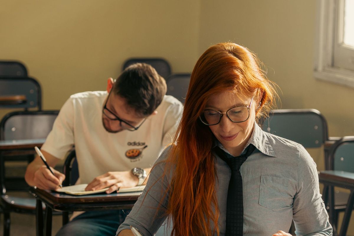 Tutor helping a student one to one at a desk