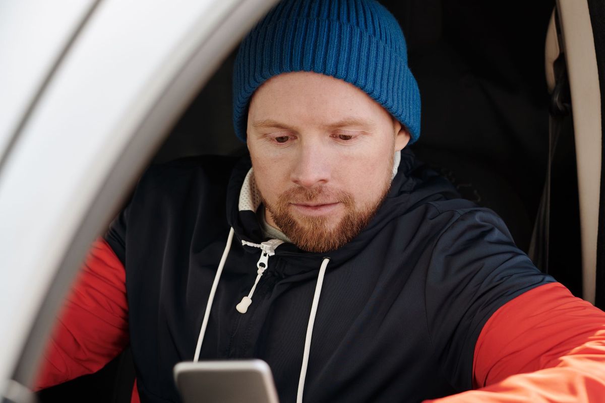 Person reading a website on a phone in daylight