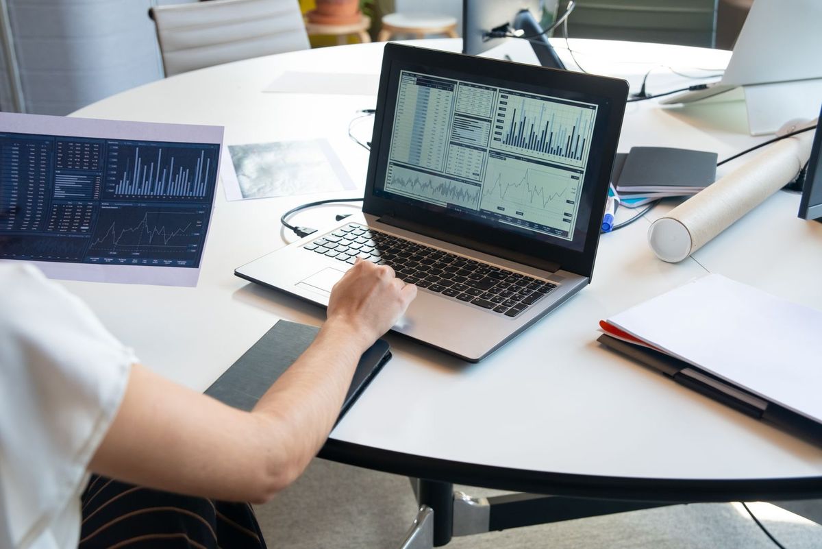 Person reviewing website visitor numbers on a laptop