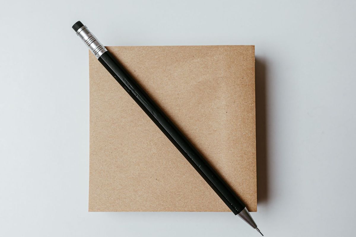 A pencil resting on a plain envelope