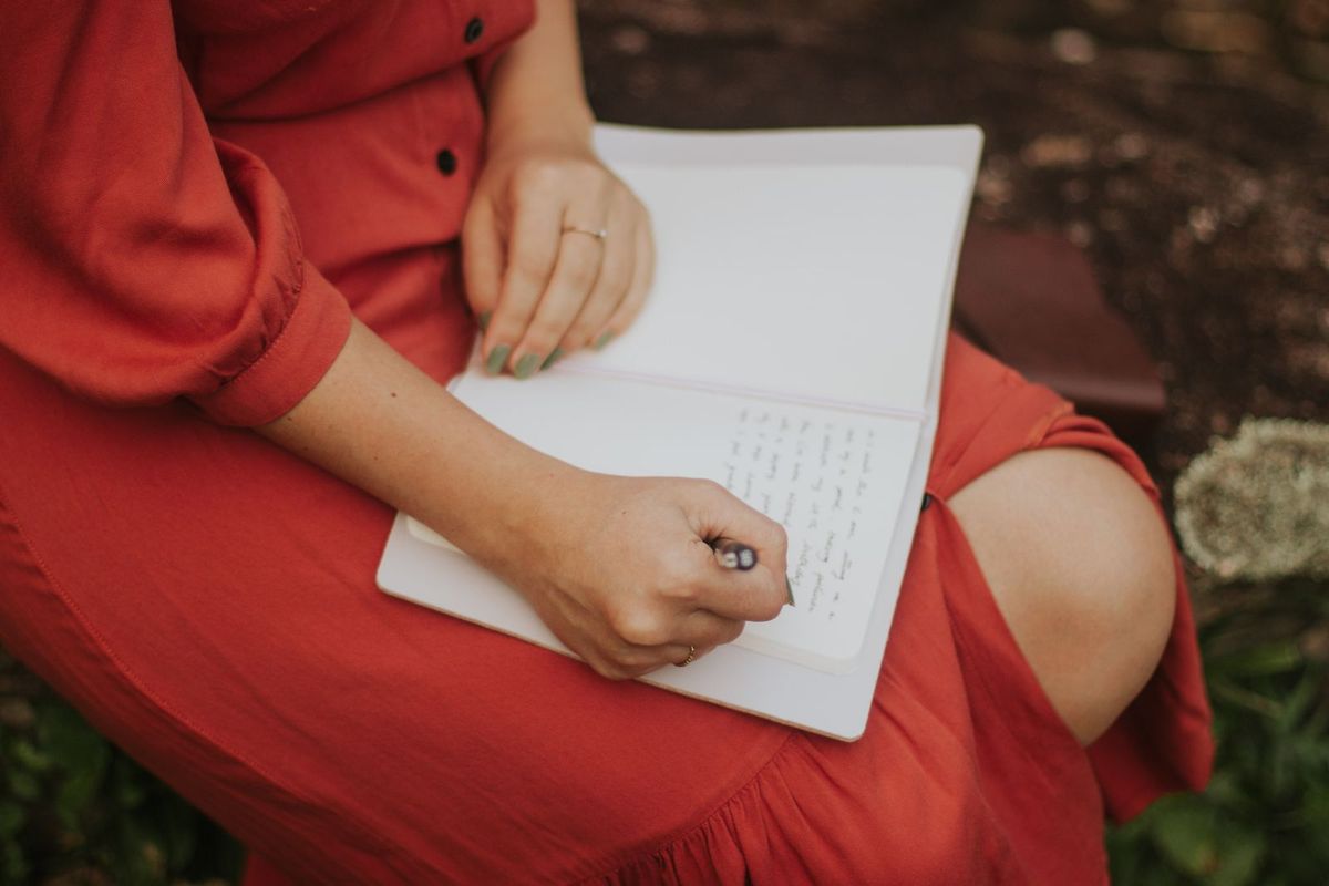 Person choosing words while writing at a desk