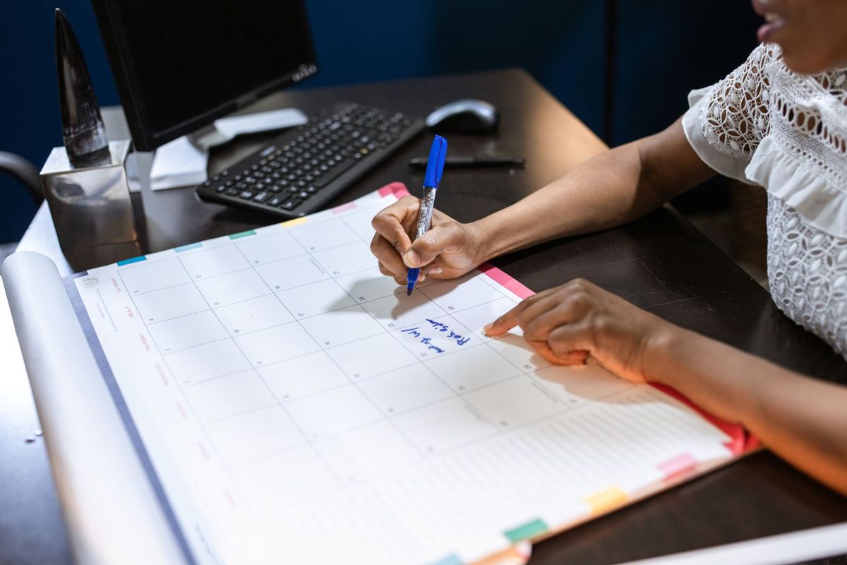 Wedding planner writing out details in a planning book